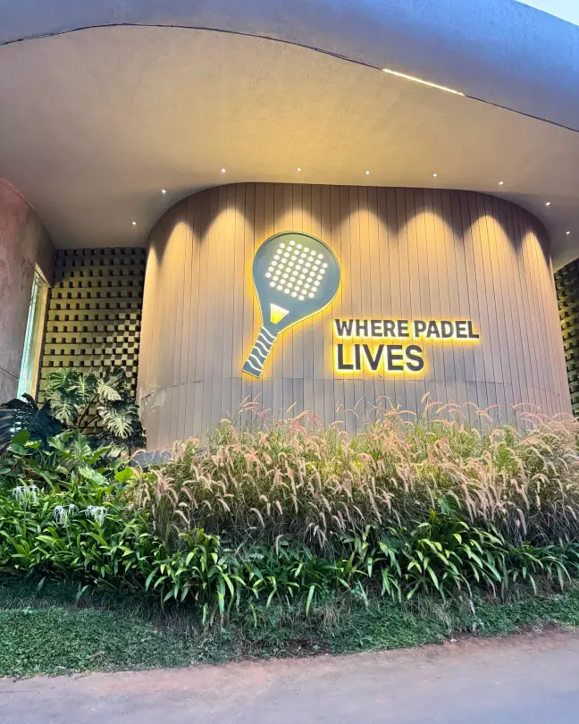 Where Padel Lives sign above planting