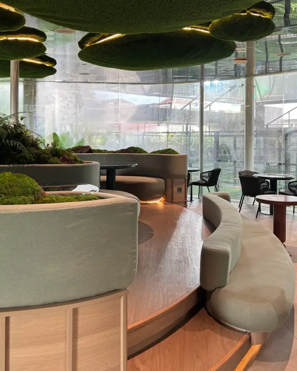 Moss-clad lounge with curved banquettes