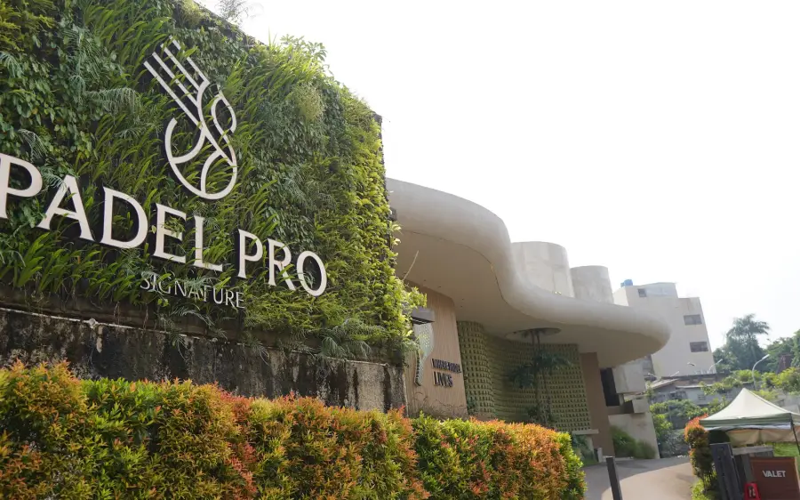 Padel Pro Signature logo on a living green wall